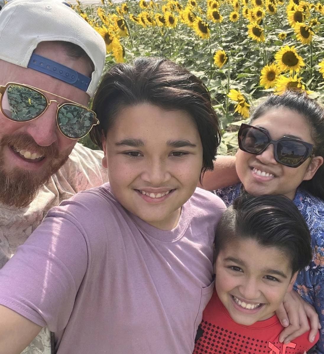 Sean, Kat, Grayson and Finn in a sunflower field